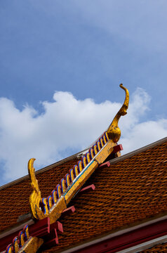 Close-up shot of the roof of a temple in Thailand, consisting of  traditional ornaments called Chofa, Bai Rakha, and Hang Hong