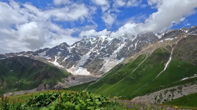 Mount Shkhara rising in wide view above alpine slopes near Ushguli, Svaneti, Georgia, travel scene for trekking routes, glacier tourism, hiking promotion, and Caucasus destination campaigns