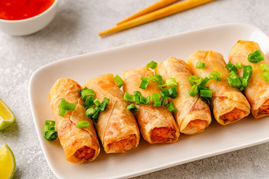 Fried spring rolls served with lime and sauce