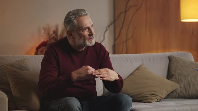 Happy man in his 50s talks with psychologist, satisfied with therapy results