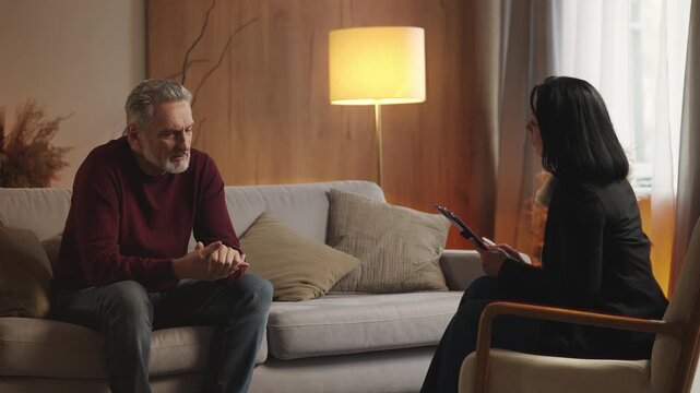 Sad middle-aged man talks to psychologist about life problems, mental health