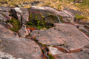 Close up view of fresh water trickling down red sandstone rocks at Razdoljski waterfall (Razdolje) near Kaludjerski Skok at Stara Planina nature reserve, Serbia. © Dragan