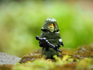 Naklejka premium Indonesia - May 9, 2023 : Toy photography concept at outdoor with unfocus green grass. Background is blurred.