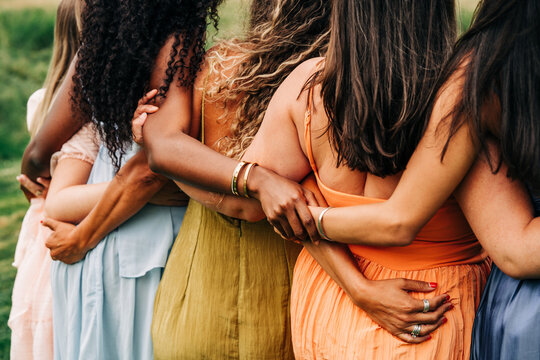 Diverse group of women stand together outdoors