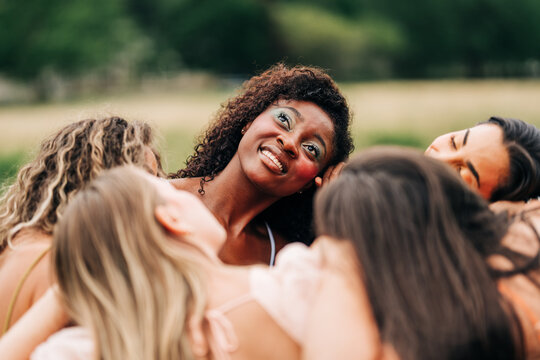 Beautiful black woman smiles supported by female friends