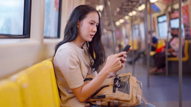 Asian stressed woman sit on subway train seat while traveling in city. 