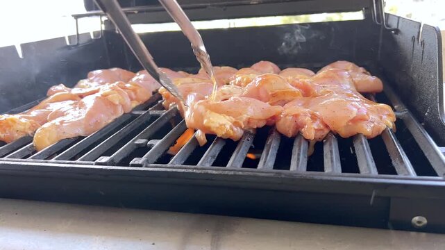 Juicy Chicken Thighs Being Grilled to Perfection on a Small Weber Grill
