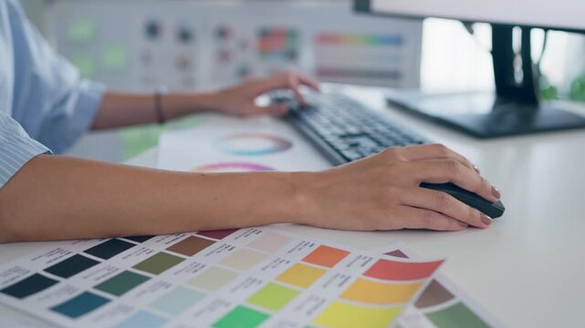 Close up of female designer working on a table in a creative workspace. 