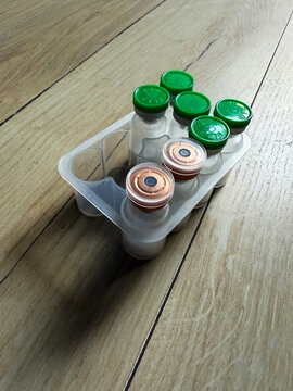 Reta, retatrutide peptide in a vial and bacteriostatic water on a wooden background.	