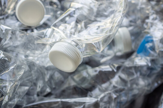crushed plastic water bottles ready for recycling process, environmental pollution concept