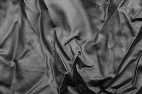 Abstract Black Rubber Latex Texture Background with Elegant Folds and Shadows