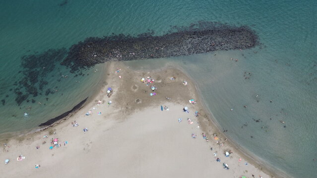 Sandy beach and blue Mediterranean Sea in Le Grau d'Agde, Herault, Occitanie, France