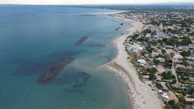 Sandy beach and blue Mediterranean Sea in Le Grau d'Agde, Herault, Occitanie, France