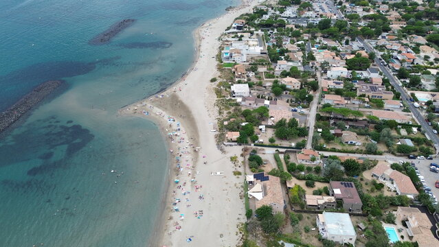 Sandy beach and blue Mediterranean Sea in Le Grau d'Agde, Herault, Occitanie, France