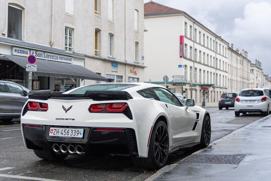 Nancy, France - July 27th 2019 : View on a white Chevrolet Corvette C7 Grand Sport parked on a street under the rain.