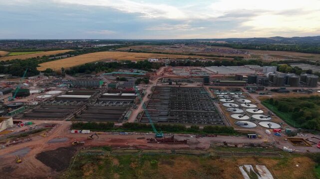 Aerial view of large municipal sewage treatment works and circular clarifier tanks in Leicestershire UK