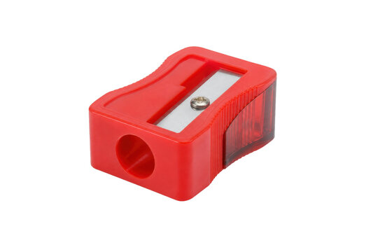 Vibrant red plastic pencil sharpener with a metal blade and transparent shaving compartment is isolated on a clean white background