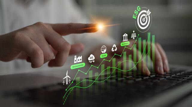 Person analyzing data with green technology symbols on a laptop representing Environmental Social Governance trends and metrics in business sustainability. Glyphic.