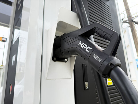 Hatyai, Thailand - Aug 24, 2026: HPC electric vehicle charging connector docked at EV charging station.