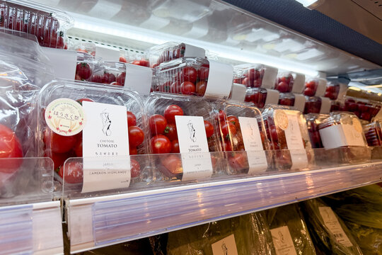 PENANG, MALAYSIA - AUG 18, 2026: Chitose tomatoes displayed on refrigerated supermarket produce shelf.