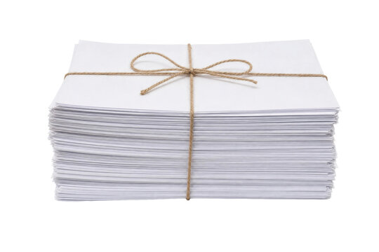 Large stack of white paper documents is neatly tied with a natural twine bow, isolated on a clean white background