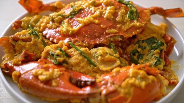 Close up cinematic footage of delicious stir fried crab with salted egg yolk sauce.