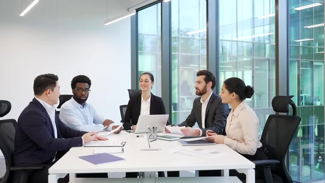 Group of diverse businesspeople talking at meeting in office. Briefing co-workers colleagues communicate at conference. Corporate team in formal wear discussing financial issues, engaging in decision