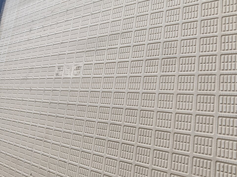 High resolution background texture featuring the embossed grid pattern on the backside of a ceramic floor tile, targeted for construction material mockups, architectural interior renderings, 3D