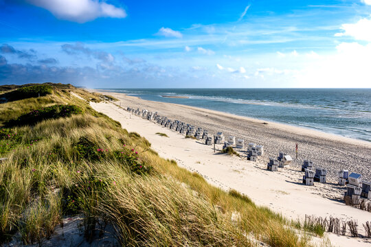 Empty beach chairs line the sandy coast of Sylt island