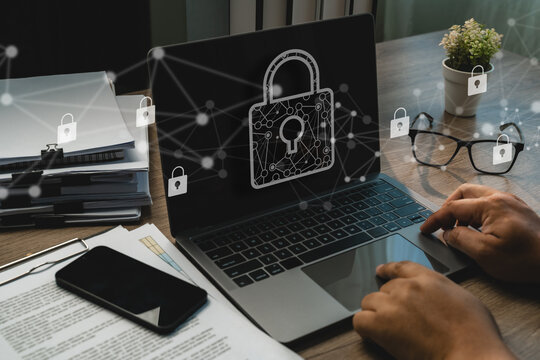 Businessman using a laptop with digital padlock network, cybersecurity, internet privacy, antivirus protection and secure data management across connected devices data security encryption