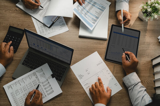 Business team meeting to brainstorm a new business project, analyzing financial reports, charts and budget data for consulting, finance planning, teamwork and professional decision making.