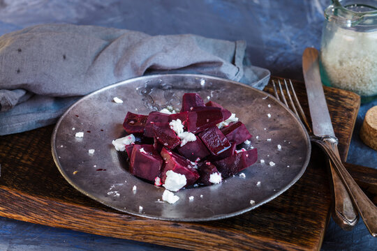 Metal plate of beetroot salad with feta and sea salt