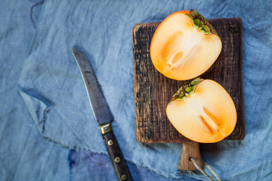 Sliced kaki on wooden board