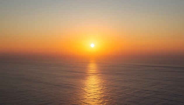 Breathtaking sunset over the calm open ocean water with golden sunlight reflecting on the surface and soft gradient sky reflection twilight peaceful landscape vacation atmosphere