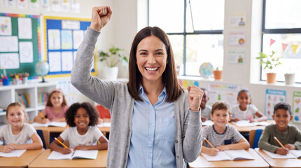 Obraz premium Female teacher celebrates student success in a bright classroom with children engaged at desks, colorful educational materials on the walls