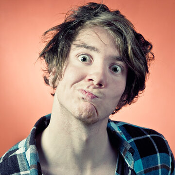 Man making pulling funny faces, portrait