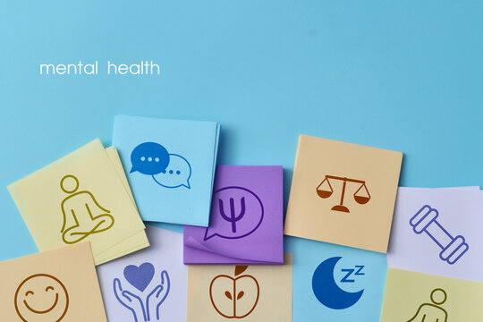 Colorful cards with symbols representing meditation, communication, emotions, balance, sleep, and wellbeing, illustrating a holistic mental health concept.