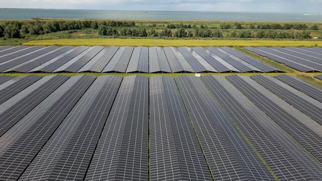 Large solar panel park on the Markermeer shore in Almere Buiten, Flevoland, Netherlands, aerial view