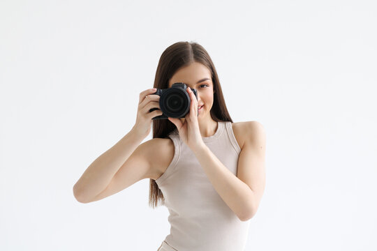 Young photographer is taking a phot isolated on white background