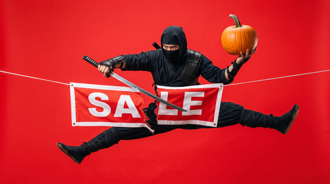 Ninja holding pumpkin, slicing "SALE" banner, symbolizing aggressive discounts and holiday shopping, suitable for promotions.