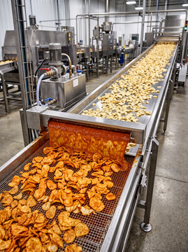 Process of coating spicy sauce on a chips in factory railway