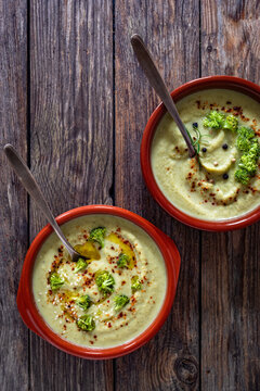 Cream of broccoli soup on wooden table. Top view

