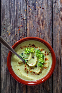 Cream of broccoli soup on wooden table. Top view

