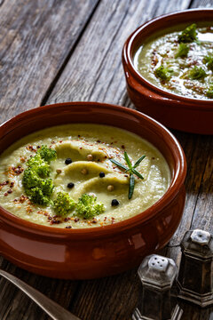 Cream of broccoli soup on wooden table
