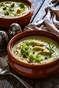 Cream of broccoli soup on wooden table
