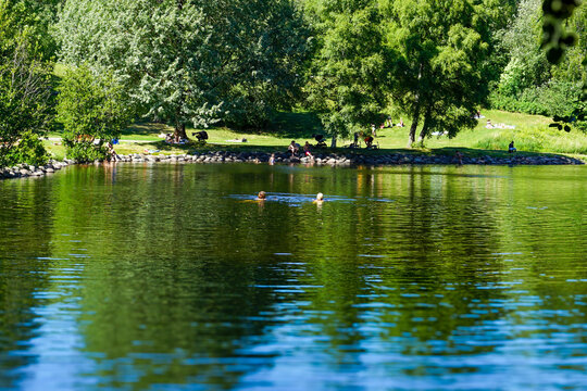 People enjoying Frysja public bath in Akerselva Oslo