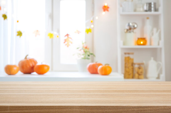 Empty dining table to place food or Halloween objects on blur kitchen window interior background decorated for holiday