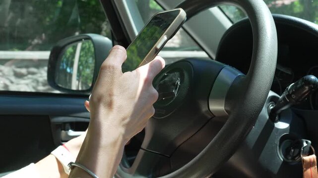 Smartphone driver navigation touchscreen smartphone user driving vehicle while navigating mobile map app in daylight
