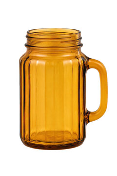 Empty amber glass mason jar mug with a handle and ribbed texture is isolated on a clean white background