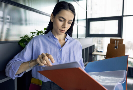 Financial documents. Checklist business report. Business professional woman reading paper financial report. Woman working analyzing financial document, chart and data. Businesswoman busy in planning